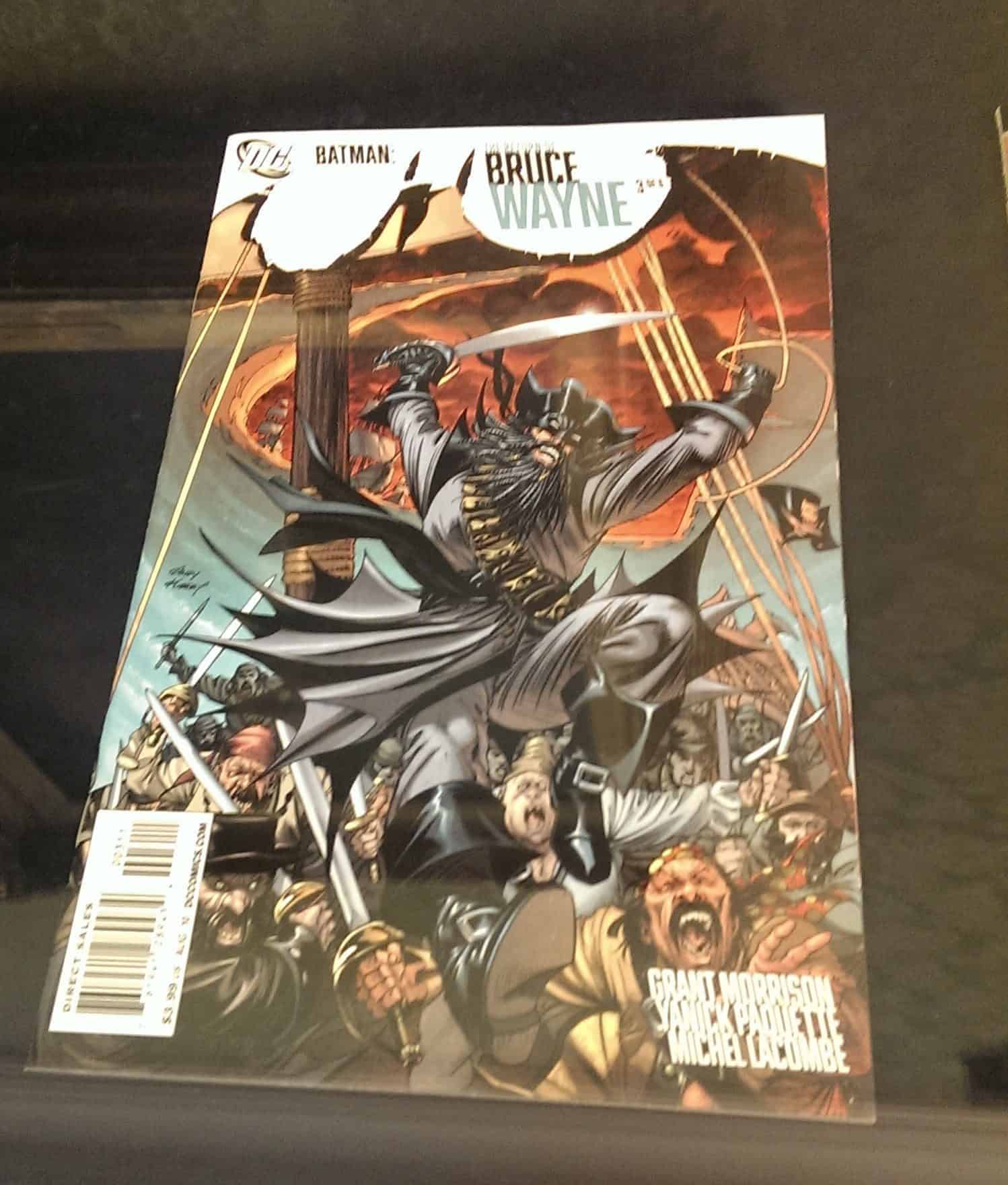 Batman in swashbuckling pirate gear on a ships mast.