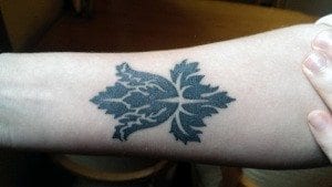 forearm with tattoo of wallpaper pattern from BBC's SHERLOCK