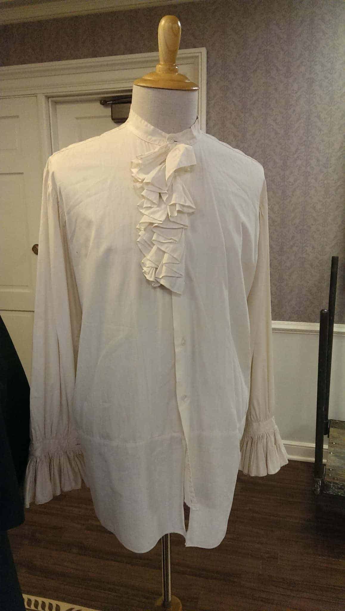 Shirt worn by Morton Lowry as Sir Hugo Baskerville in THE HOUND OF THE BASKERVILLES (1939). Long, loose cream shirt with ruffled collar.