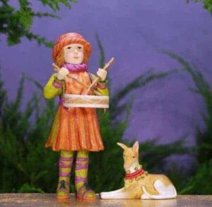 Garishly-dressed drummer boy with Italian Greyhound.