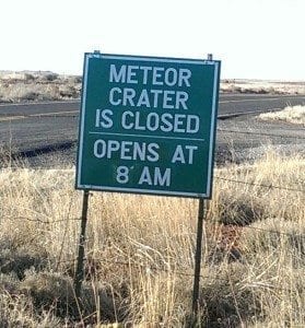 sign: Meteor Crater is closed. Opens at 8 am.