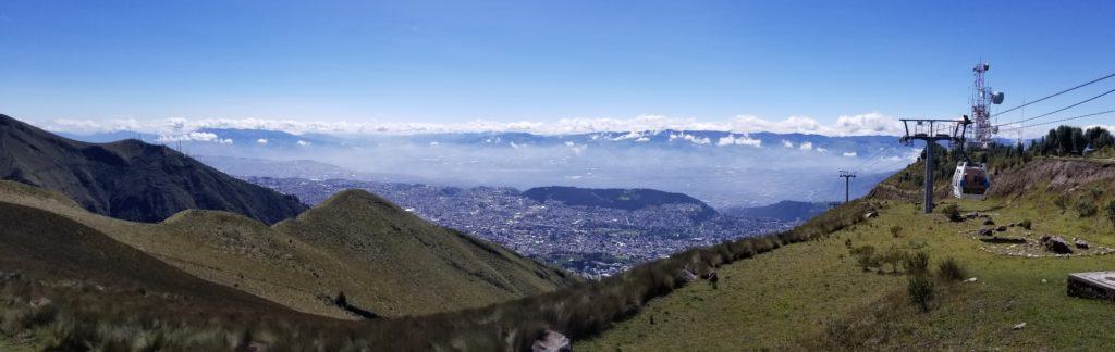 panaramic view of Quito showing mountains and smog